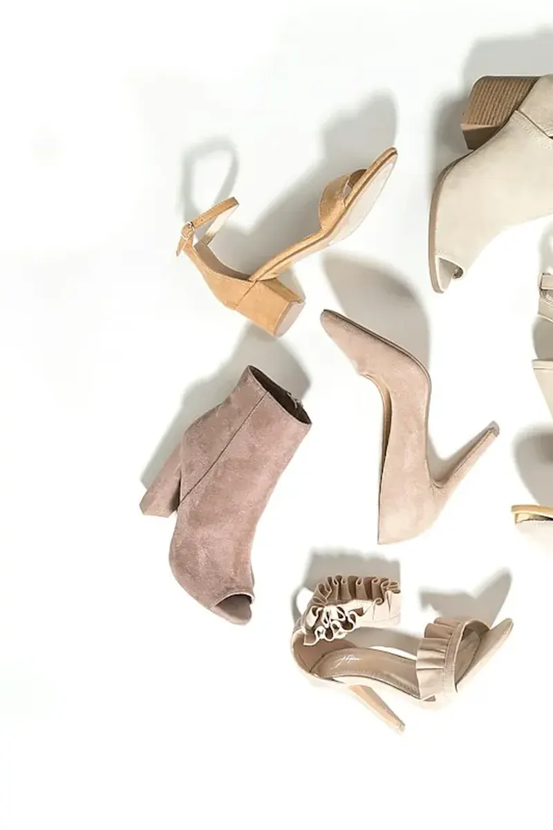 Brown suede knee-high boots styled with a midi skirt and knit sweater for fall